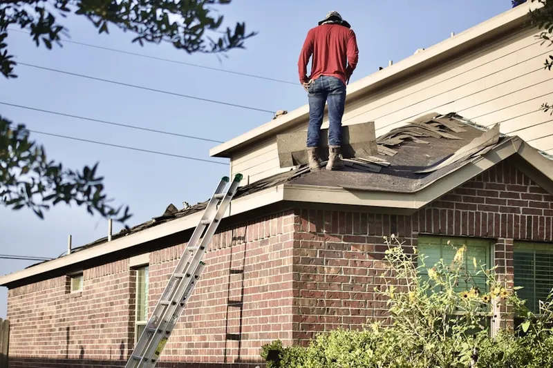 Professional roofer working on a residential roof in Theodore Roosevelt Island